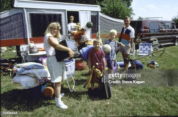 Vacationer Don Seger and his family , wife Judy and sons Andy, Nick, Brian and Christopher, outside camper with various sports and camping equipment,...