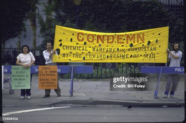 Signs holding Iraqui president Saddam Hussein Takriti responsible for Iraqi chemical warfare attacks on Iraqi Kurds in Halabcha. Signs being held by...