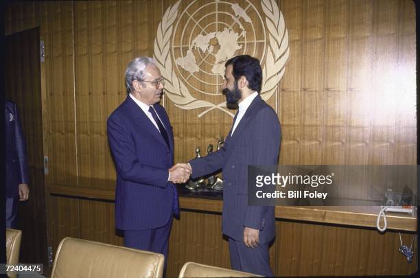Secretary General Javier Perez de Cuellar shaking hands with Iranian Foreign Minister Ali Akbar Velayati during the UN mediated Iran-Iraq war peace...