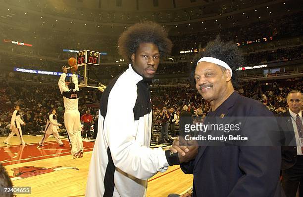 The Reverend Jesse Jackson acknowledges Ben Wallace of the Chicago Bulls prior to the start of team's NBA season opening home game with the...