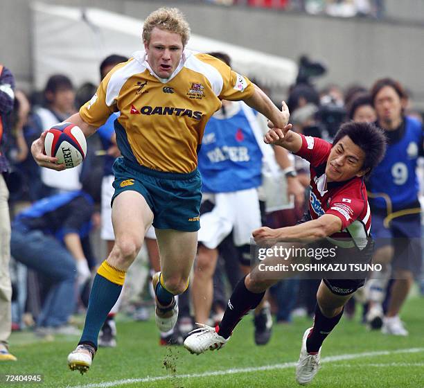 Australian Prime Minister's XV WTB Lloyd Johansson scores a try against Japan during a friendly match at the Prince Hitachi Memorial stadium in Tokyo...