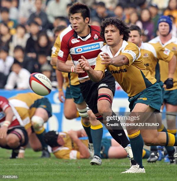 Australian Prime Minister's XV standoff-half Daniel Halangahu passes the ball during a friendly match at the Prince Hitachi Memorial stadium in Tokyo...