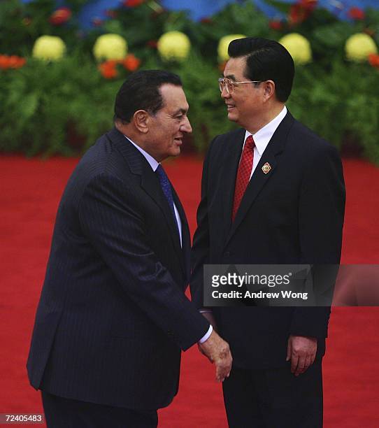 Egyptian President Hosni Mubarak is greeted by Chinese President Hu Jintao during the welcoming ceremony for representatives attending the Beijing...