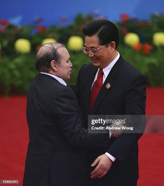 Algerian President Abdelaziz Bouteflika hugs Chinese President Hu Jintao during the welcoming ceremony for representatives attending the Beijing...