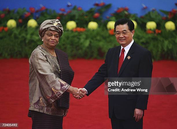 Liberian President Ellen Johnson Sirleaf is greeted by Chinese President Hu Jintao during the welcoming ceremony for representatives attending the...