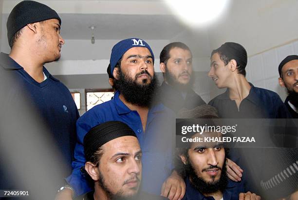 Suspected members of an Al-Qaeda cell in Yemen are seen behind the bars during a hearing at the state security appeal court in Sanaa 04 November...