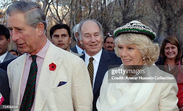 Camilla, Duchess of Cornwall, watched by Prince Charles, Prince of Wales and SAS Prince Karim Aga Khan IV the hereditary Imam of the Shia Imami...