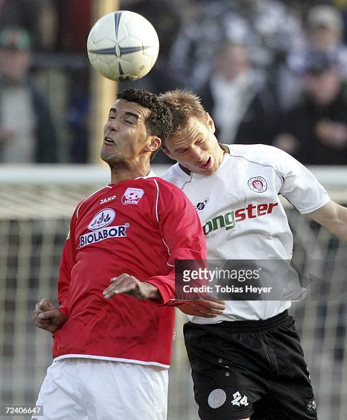 Joseph Laumann from Ahlen, and St. Paulis Carsten Rothenbach are callenging for the ball during the Third League match between Rot Weiss Ahlen and FC...