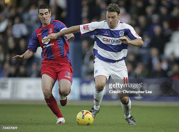 Kevin Gallen of Queens Park Rangers holds off Mark Kennedy of Crystal Palace during the Coca-Cola Championship match between Queens Park Rangers and...