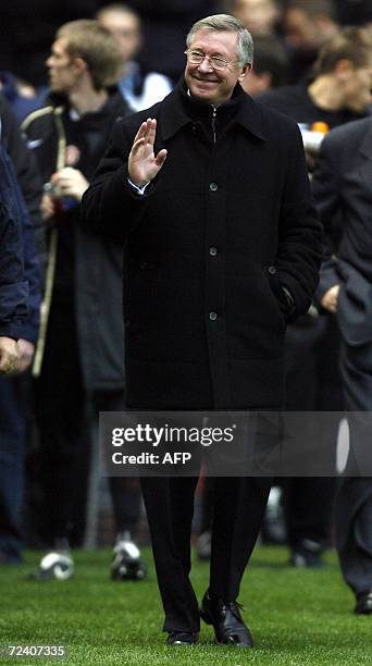 Manchester, UNITED KINGDOM: Manchester United manager Sir Alex Ferguson waves to fans prior to kick off against Portsmouth during their English...