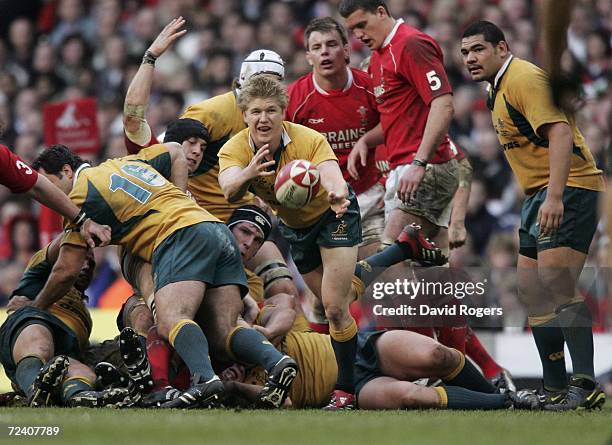 Josh Valentine of Australia passes the ball out from a ruck during the Invesco International match between Wales and Australia at the Millennium...