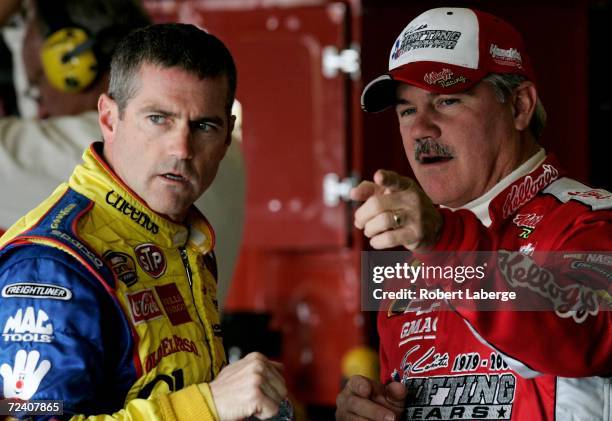 Bobby Labonte, driver of the Cheerios/Betty Crocker Dodge, talks with his brother Terry labonte, driver of the Kellogg's Chevrolet, during practice...