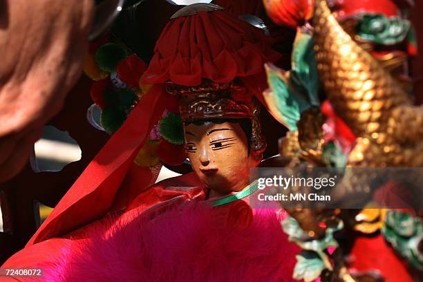 Worker decorates a Tin Hau statue for the parade of the 'Tai Ping Qing Jiao' festival at Shek O on November 4, 2006 in Hong Kong, China. 'Tai Ping...