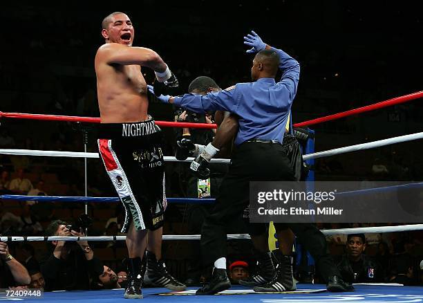 Chris Arreola jumps in the air as referee Kenny Bayless comes in to stop the fight in the 7th round against Damian Wills during their heavyweight...