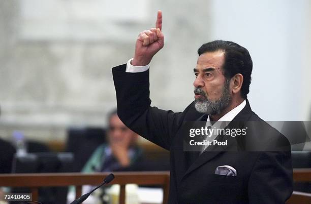 Former Iraqi President Saddam Hussein shouts as he receives his guilty verdict during his trial in the fortified 'green zone', on November 5, 2006 in...