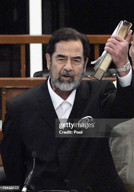 Former Iraqi President Saddam Hussein shouts as he receives his guilty verdict during his trial in the fortified 'green zone', on November 5, 2006 in...