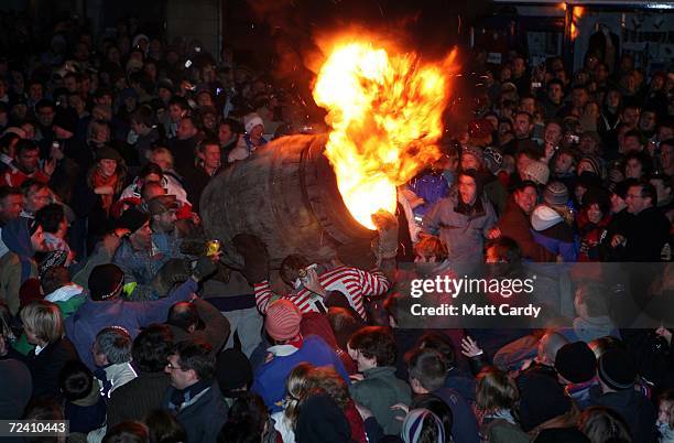 Man runs with a burrning barrel soaked in tar on November 4 2006 in Ottery St Mary, Devon, England. The 400-year-old event at Ottery St Mary's...