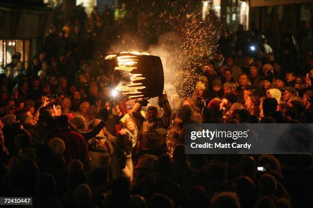 Man runs with a burrning barrel soaked in tar on November 4 2006 in Ottery St Mary, Devon, England. The 400-year-old event at Ottery St Mary's...