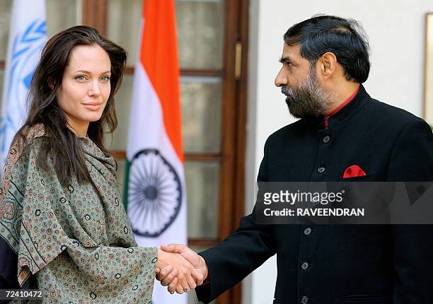 Hollywood film actress and UNHCR good-will ambassador, Angelina Jolie shakes hands with the Indian Minister of State for External Affairs, Anand...