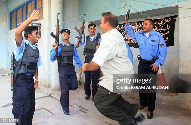 Basra Police Iraqi police in Basra celebrate the guilty verdict handed down today ...