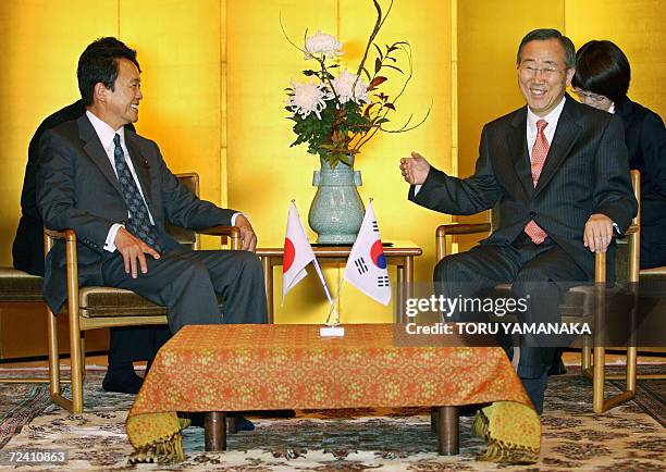 South Korean Foreign Minister Ban Ki-Moon chats with his Japanese counterpart Taro Aso prior to their talks at a Japanese restaurant in Tokyo, 05...