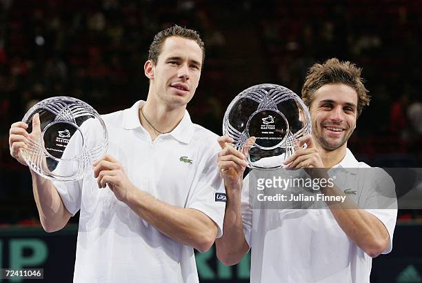 Arnaud Clement and Michael Llodra of France celebrate with the trophies after defeating Fabrice Santoro of France and Nenad Zimonjic of Serbia &...