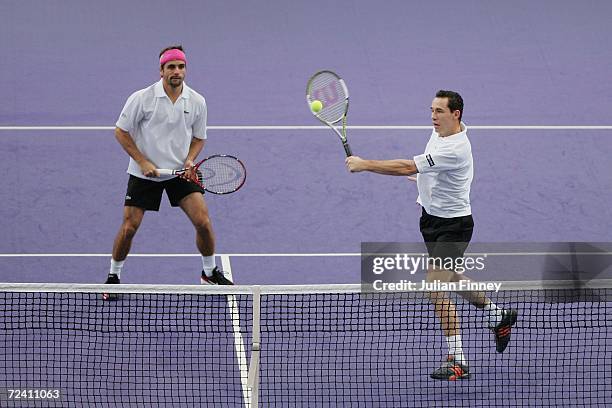 Arnaud Clement and Michael Llodra of France in action in their match against Fabrice Santoro of France and Nenad Zimonjic of Serbia & Montengro in...