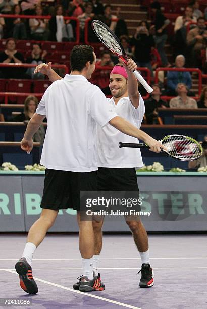Arnaud Clement and Michael Llodra of France celebrate defeating Fabrice Santoro of France and Nenad Zimonjic of Serbia & Montengro in the doubles...