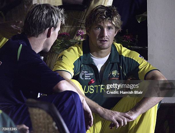 Brett Lee and Shane Watson of Australia chat outside the dressing rooms as rain delays play during the final of the ICC Champions Trophy between...