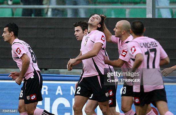 Palermo's defender Christian Zaccardo is congratulated by his teammates Mark Bresciano of Australia during their Italian Serie A football match at...