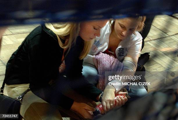 Prague, CZECH REPUBLIC: Two women check the quality of a vibrator 05 November 2006 at the 12th Czech Erotic Fair trade in Prague. Since the Velvet...