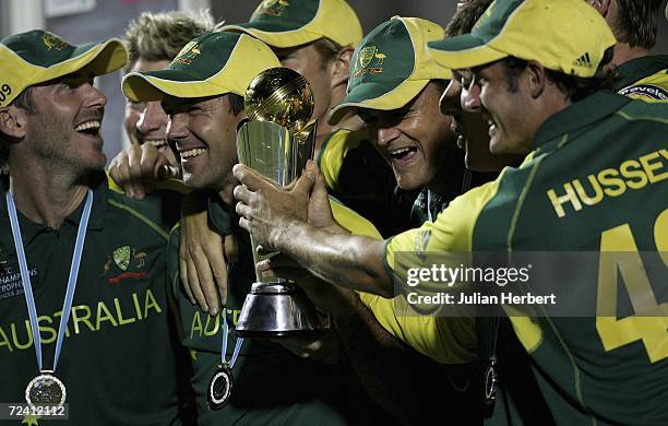 Australian players celebrate with the trophy after winning the final of The ICC Champions Trophy match between Australia and The West Indies at The...