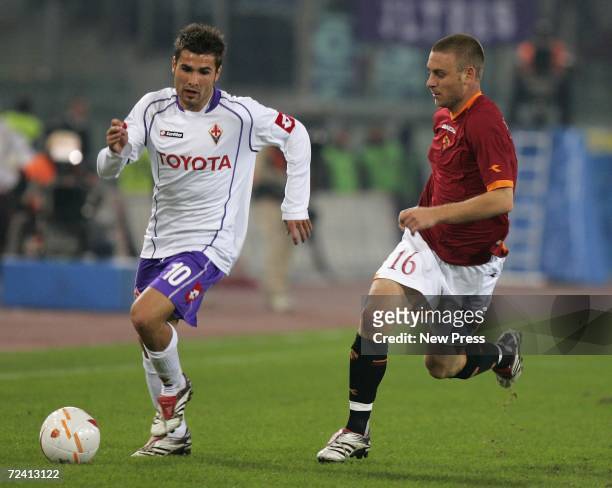 Adrian Mutu of Fiorentina competes with Daniele De Rossi of Roma during the Serie A match between Roma and Fiorentina at Olimpico stadium on November...