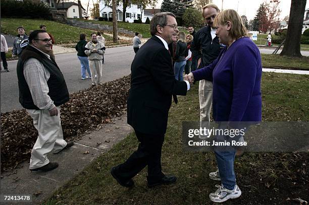 Summit County Republican Party Alex Arshinkoff watches as U.S. Senator Mike DeWine and Mayor of Cuyahoga Falls Don Robart stop to shake talk with a...