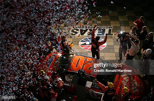 Tony Stewart, driver of the The Home Depot, celebrates in Victory Lane his victory in the NASCAR Nextel Cup Series Dickies 500 as confetti falls from...