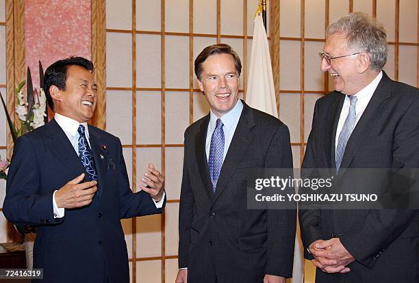 Visiting US under secretaries of state, Nicholas Burns and Robert Joseph , share a laugh with Japanese Foreign Minister Taro Aso prior to their talks...