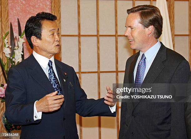 Japanese Foreign Minister Taro Aso chats with US Under Secretary of State Nicholas Burns prior to their talks at Aso's office in Toyko 06 November...