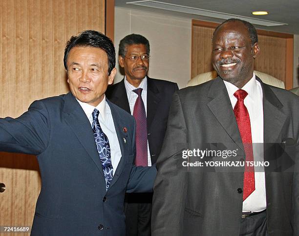 Sudanese Foreign Minister Lam Akol is greeted by his Japanese counterpart Taro Aso prior to their talks at Aso's office in Tokyo, 06 November 2006....