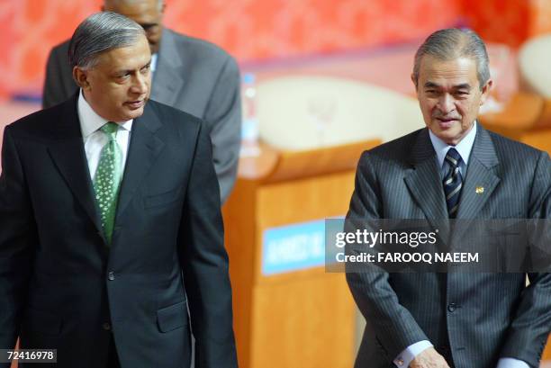 Malaysian Prime Minister Abdullah Ahmad Badawi and his Pakistani counterpart Shaukat Aziz leave after attending the opening session of second World...