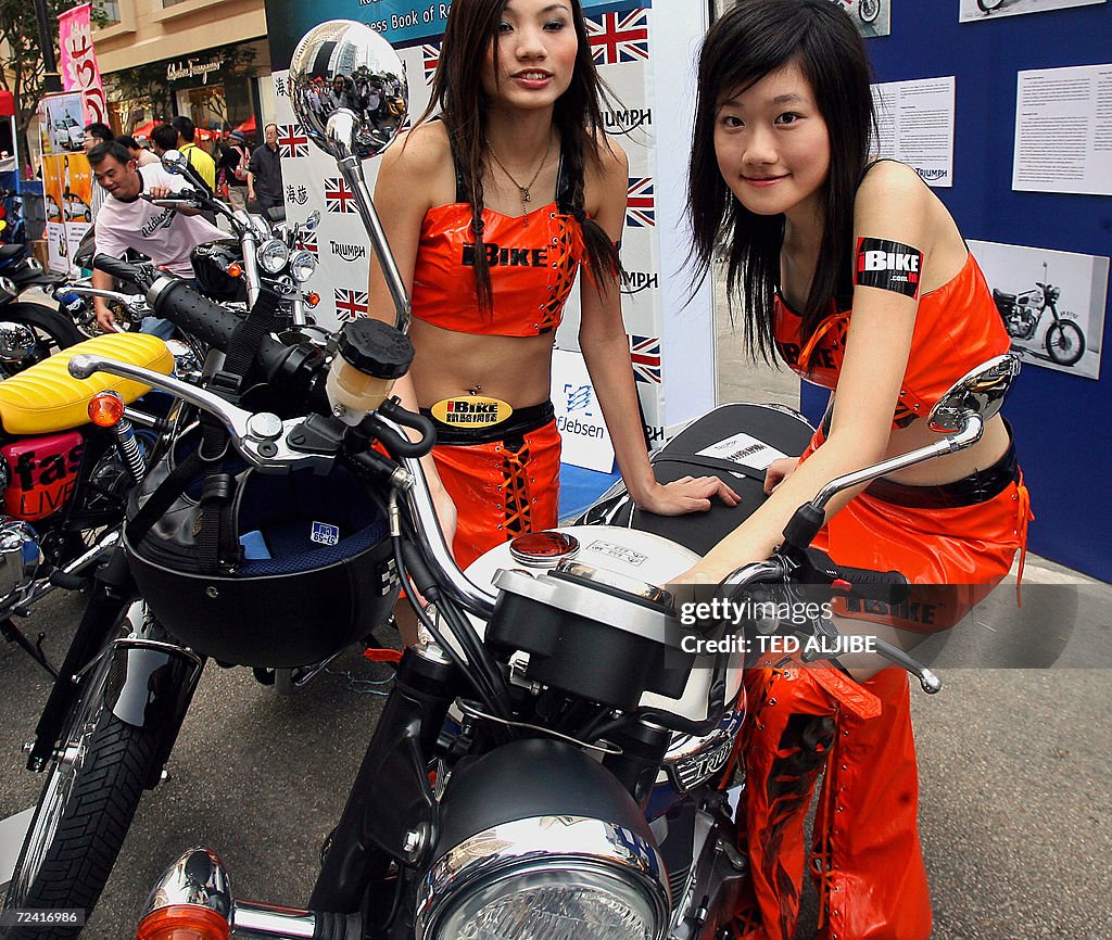 Two promotional girls pose next to a Bri