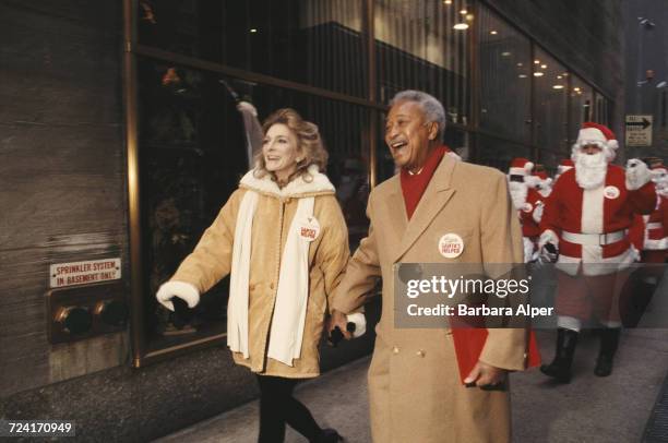 American singer-songwriter Judy Collins and former Mayor of New York, David Dinkins, with Volunteers of America Santas at the Rockefeller Center, New...