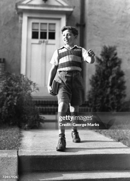 boy (10-11) on way to school, (b&w) - 20th century stock pictures, royalty-free photos & images