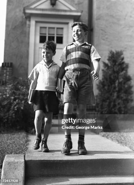 two brothers (6-7, 10-11) on way to school, (b&w), - sweater vest stock pictures, royalty-free photos & images