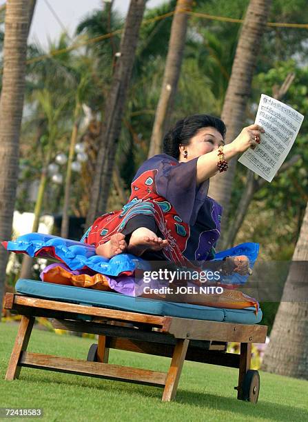 Former Philippines first lady Imelda Marcos takes part in a photo shoot beside the bayside pool of a top hotel in Manila, 06 November 2006, for the...