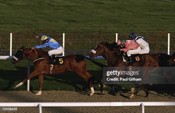 Three Boars ridden by Silvestre de Sousa leads Abbeygate ridden by Micky Fenton on its way to winning the Jump Racing Here Tomorrow Banded Stakes...