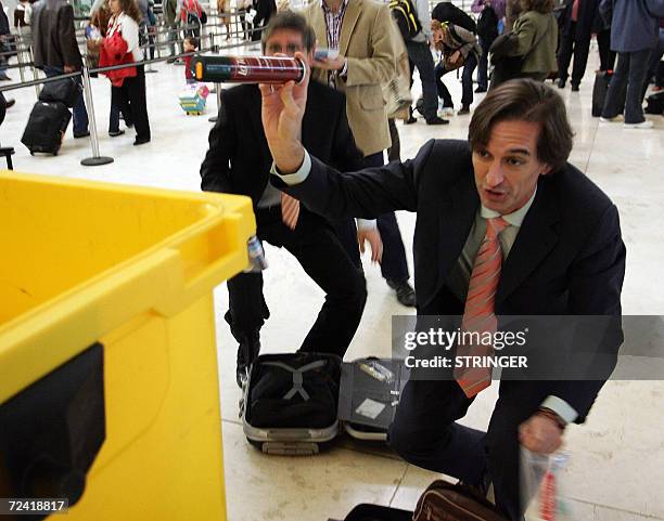 Travellers repack their wash bags following EU-wide hand luggage rules that came into effect, 06 November 2006. The new regulations allow limited...