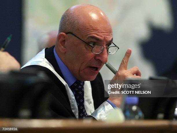 Iraqi Judge Rauf Rashid Abdel Rahmen addresses former Iraqi President Saddam Hussein after sentencing him to death during his trial in Baghdad's...