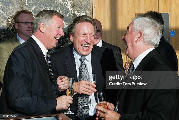 Sir Alex Ferguson of Manchester United laughs with Neil Warnock and Roy Evans at the lunch to celebrate the 20th anniversary of his arrival at Old...