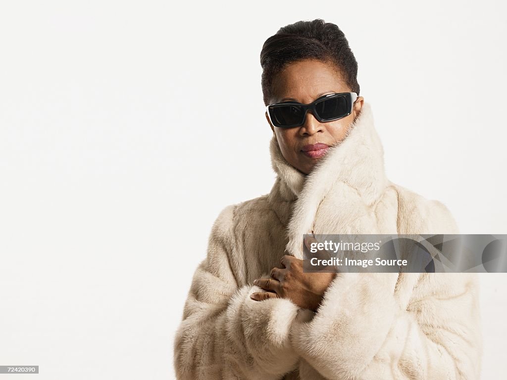 Woman in a fur coat and sunglasses