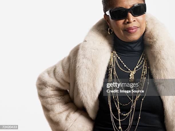 woman wearing fur coat and jewelry - bling bling stock pictures, royalty-free photos & images